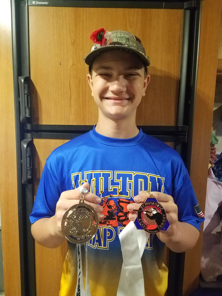 Kaden Hodge displays his medals from the 2021 State Trap Shoot
