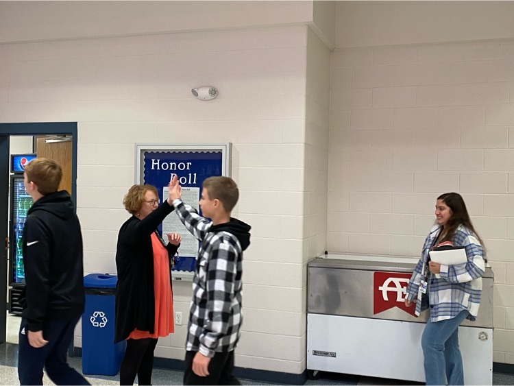 Principal Arthur-Miller gives high fives as the Sophomores enter the commons